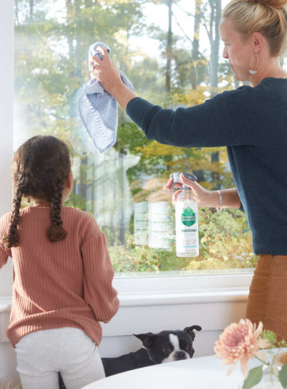 Mom and daughter cleaning windows