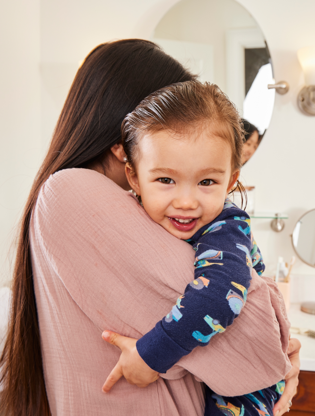 Parent hugs a smiling child