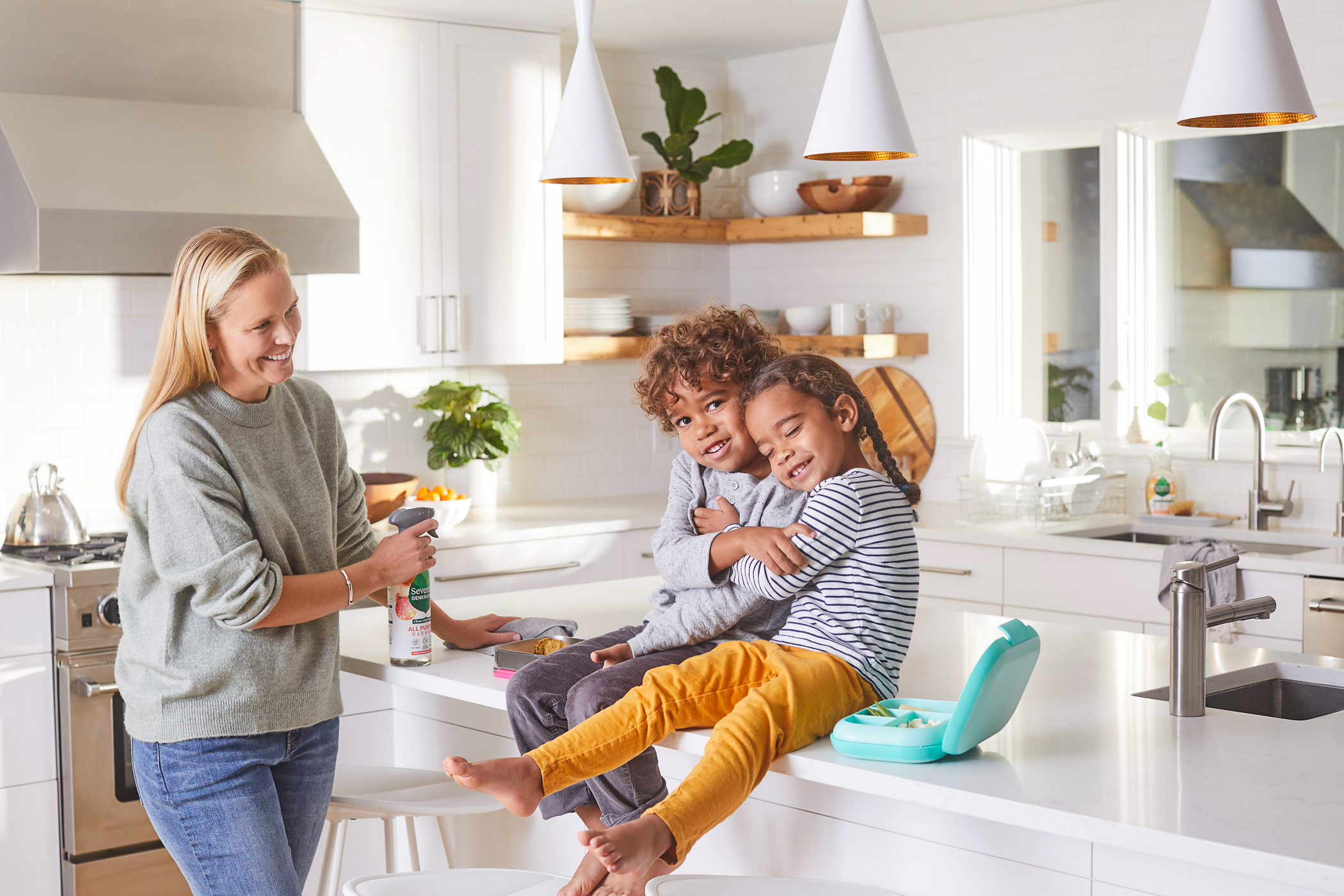 Family cleaning kitchen counter.