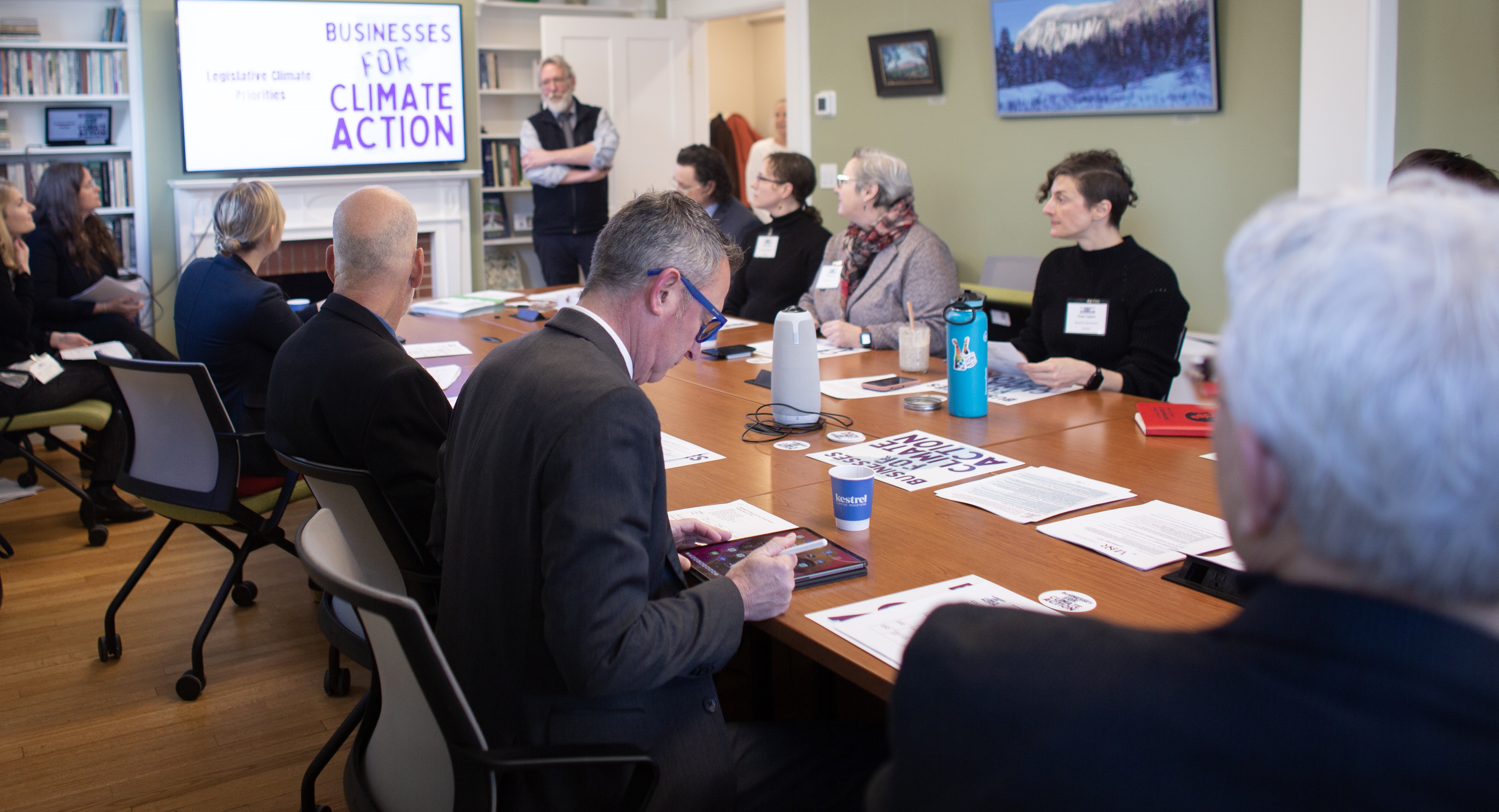 various business representatives at table discussing Climate Action 