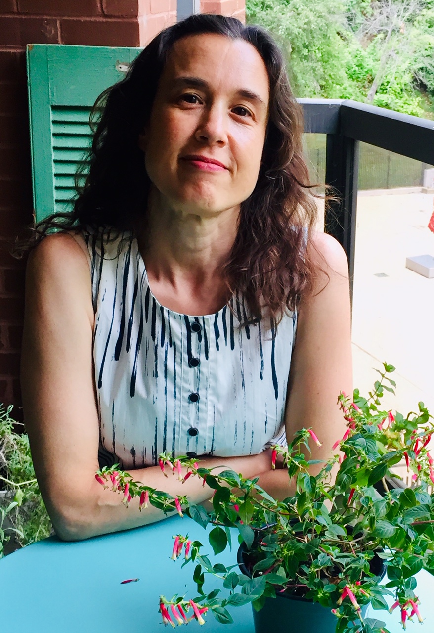 Sarah Newman sitting at table on balcony