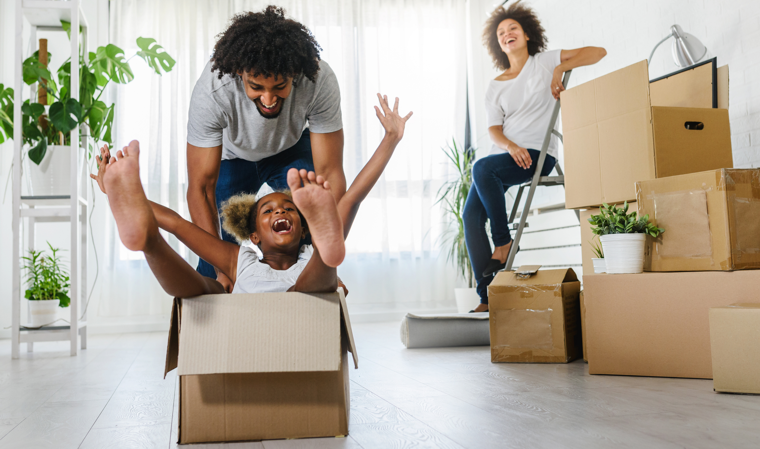 Family having fun with moving boxes.