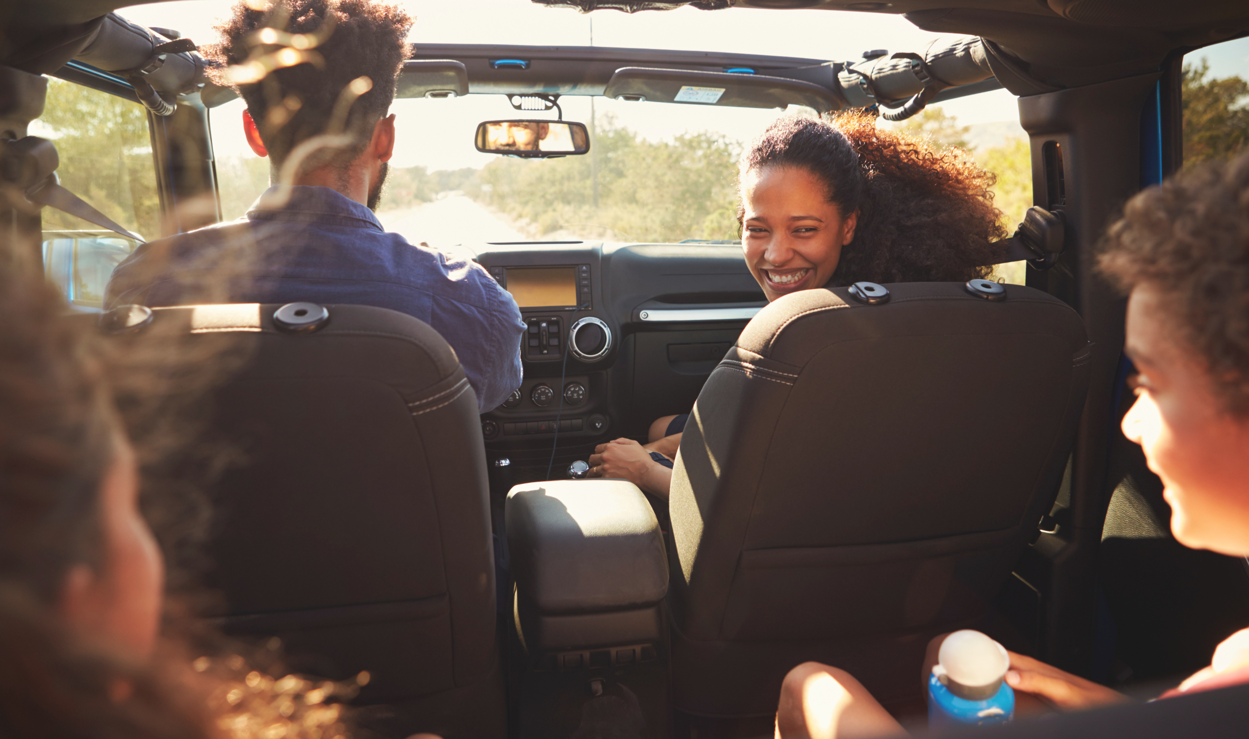 Family in car on road trip - Travel Cleaning Kit Hero Image