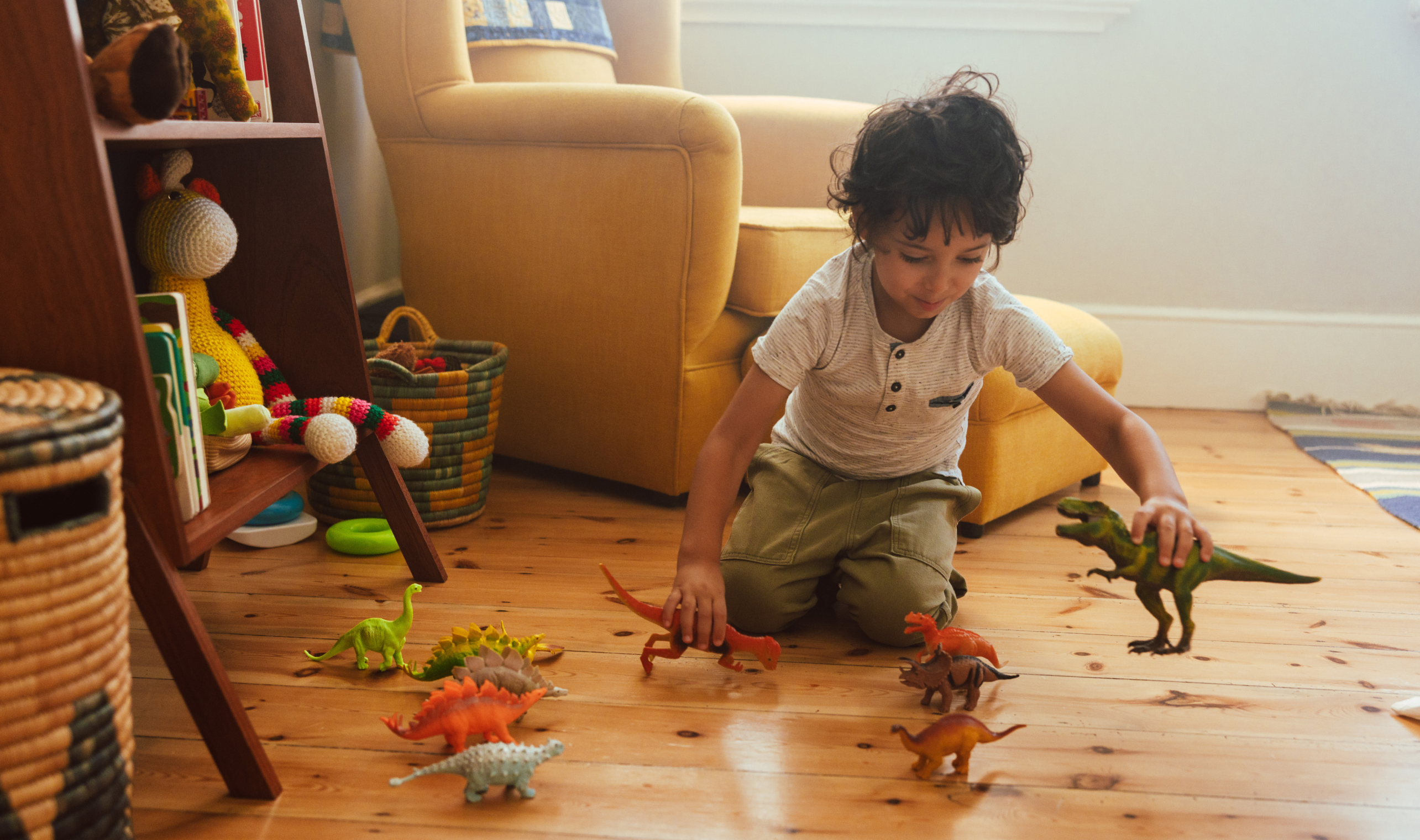 Child playing with dinosaur toys