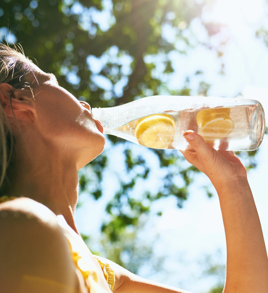 Cool Down - Person drinking lemon-infused water on sunny day