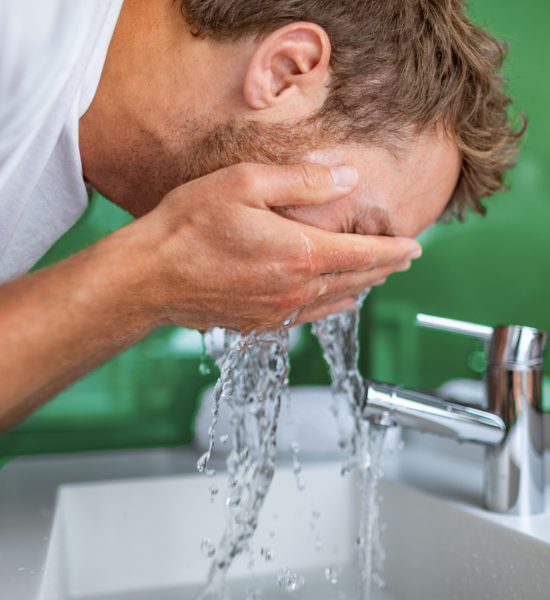 Person washing face in sink