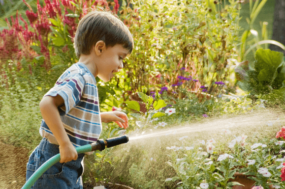 Toddler Using Water Hose