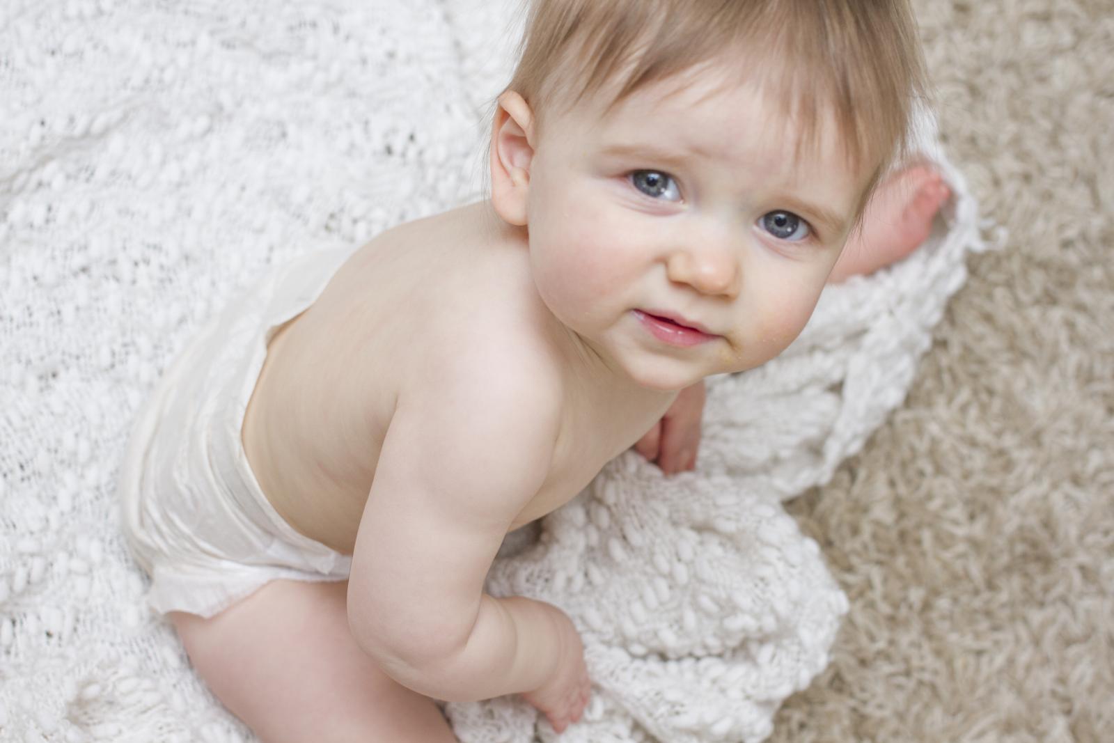 Child Sitting on Blanket