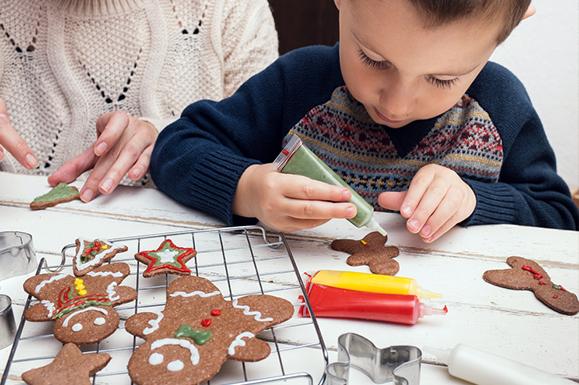 Child Decorating Gingerbread Cookie