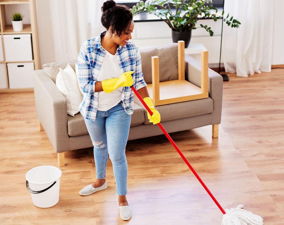 Woman cleaning laminate floor with mop