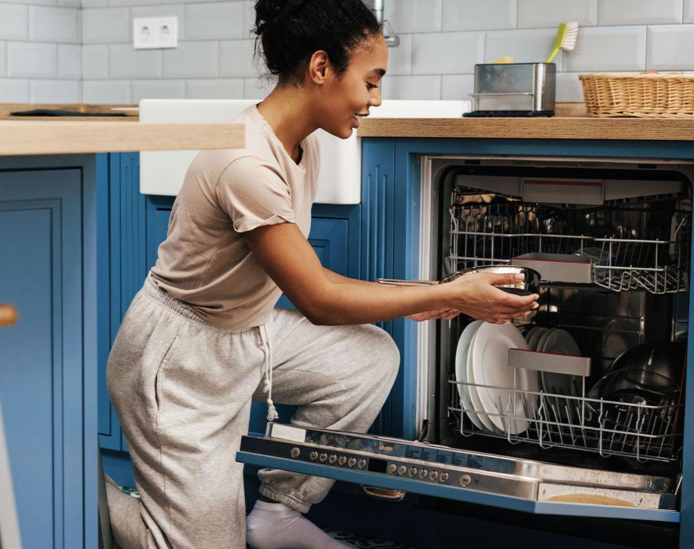 Image of person putting dishes in a dishwasher