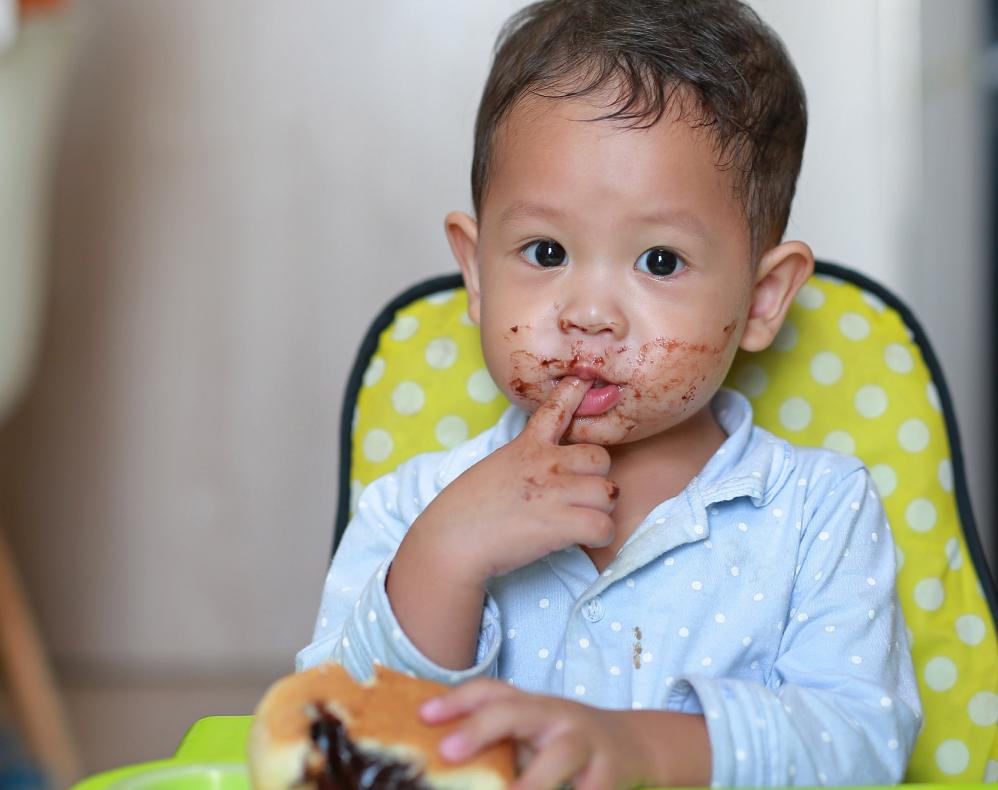 Baby Making a Mess with Chocolate