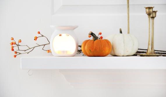 Lit Candle and Pumpkins