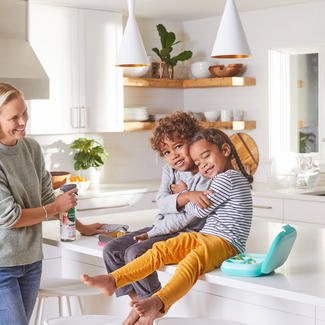 Family cleaning kitchen counter.