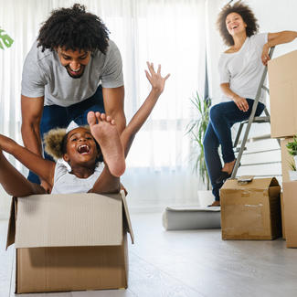 Family having fun with moving boxes.