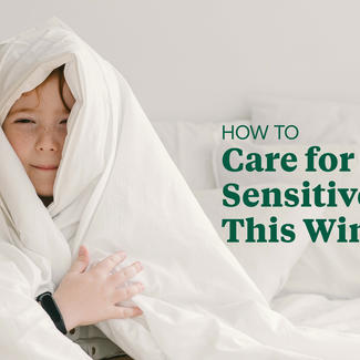 Child wrapped in white blanket. How To Care for Sensitive Skin this Winter
