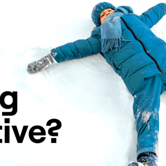 Child in snow making a snow angel.