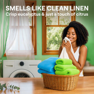 Text reads " Smells like clean linen crisp eucalyptus & just a touch of citrus". The image shows a dark skin women in a laundry room smiling while holding up a clean white towel to her face.
