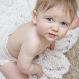 Child Sitting on Blanket