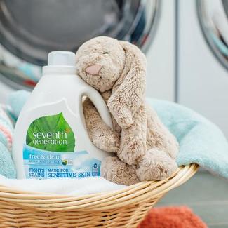 Seventh Generation Laundry Detergent with a Pile of Clothes