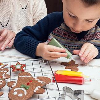 Child Decorating Gingerbread Cookie