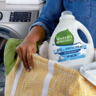 Woman holding laundry detergent in a basket