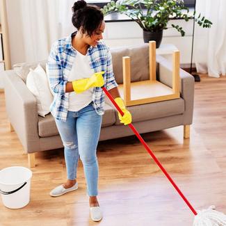 Woman cleaning laminate floor with mop