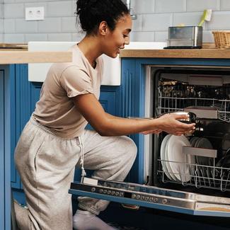 Image of person putting dishes in a dishwasher