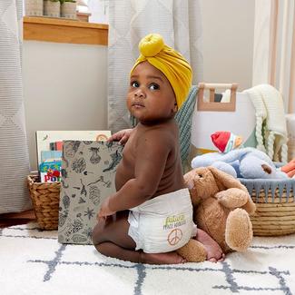 Baby is wearing a yellow turban and wearing a seventh generation diaper