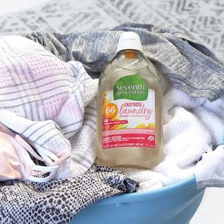 Seventh Generation Easy Dose bottle sitting in laundry basket full of clothes