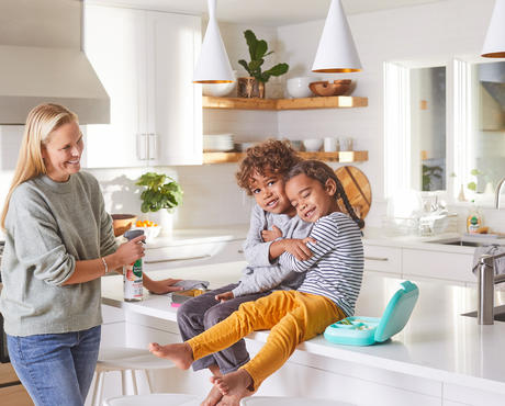 Family cleaning kitchen counter.