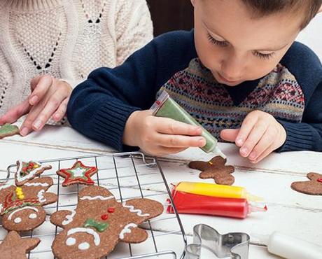 Child Decorating Gingerbread Cookie