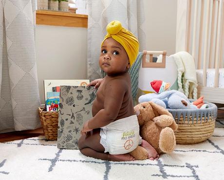 Baby is wearing a yellow turban and wearing a seventh generation diaper