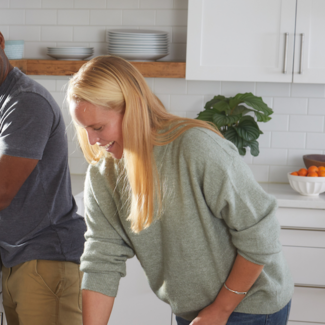 Man and woman loading a dishwasher