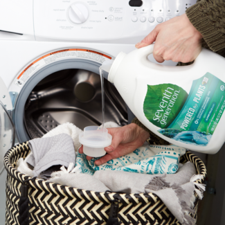 Liquid laundry detergent pouring into cap