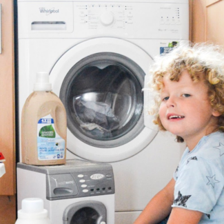 Child in front of a washing machine