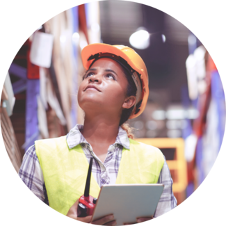 Supply Chain worker wears hardhat and looks up while checking list