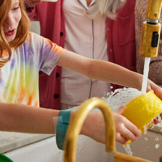 Child washing dishes