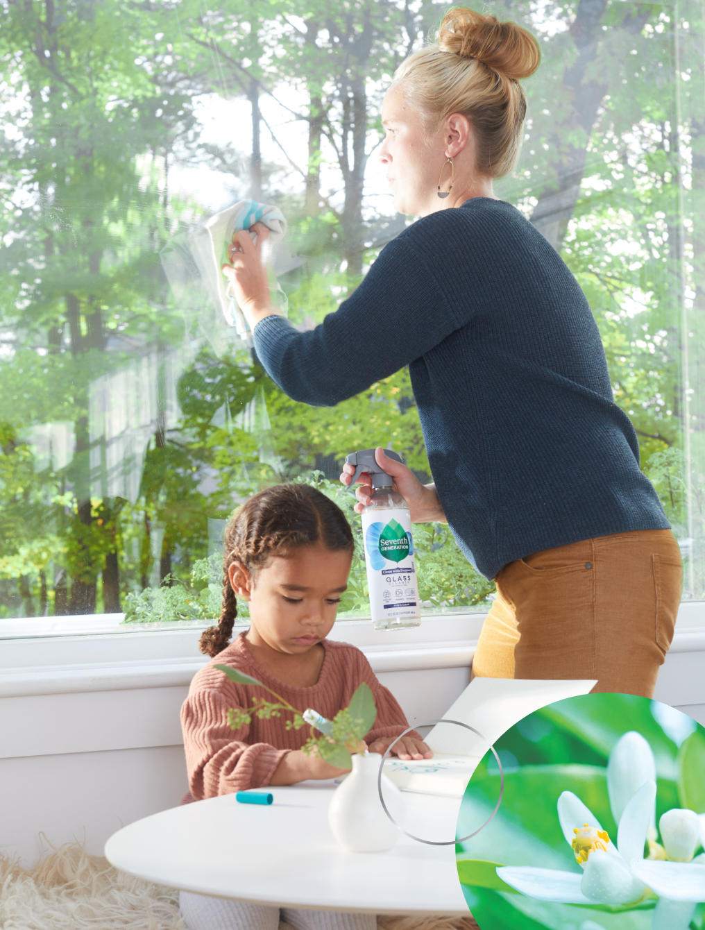 woman cleaning windows near child
